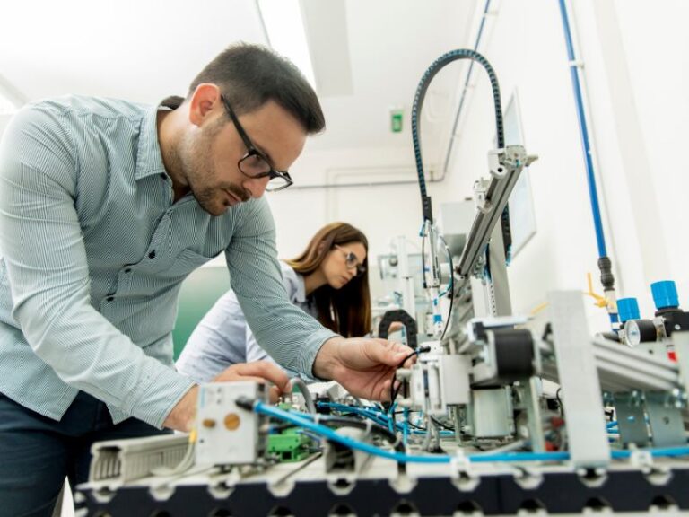 Engineers inspecting a large manufacturing facility, highlighting the role of aftermarket parts manufacturers in customizing medical equipment