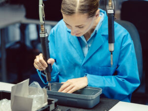 Engineers working on advanced machinery, highlighting the precision and expertise in outsourced product assembly services