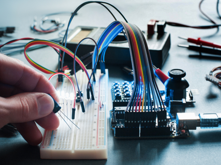 Close-up of an electronics prototype being developed using specialized equipment by an electronics prototype company