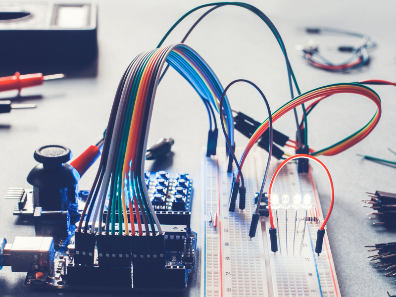 An electronics prototype company technician working on an electronics prototype to improve design and functionality