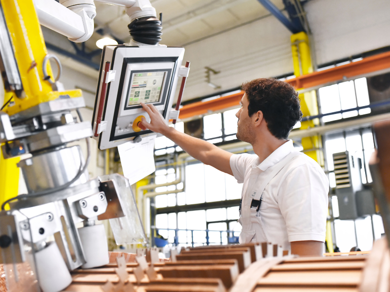 An engineer monitoring machinery at contract manufacturing services facility in USA.