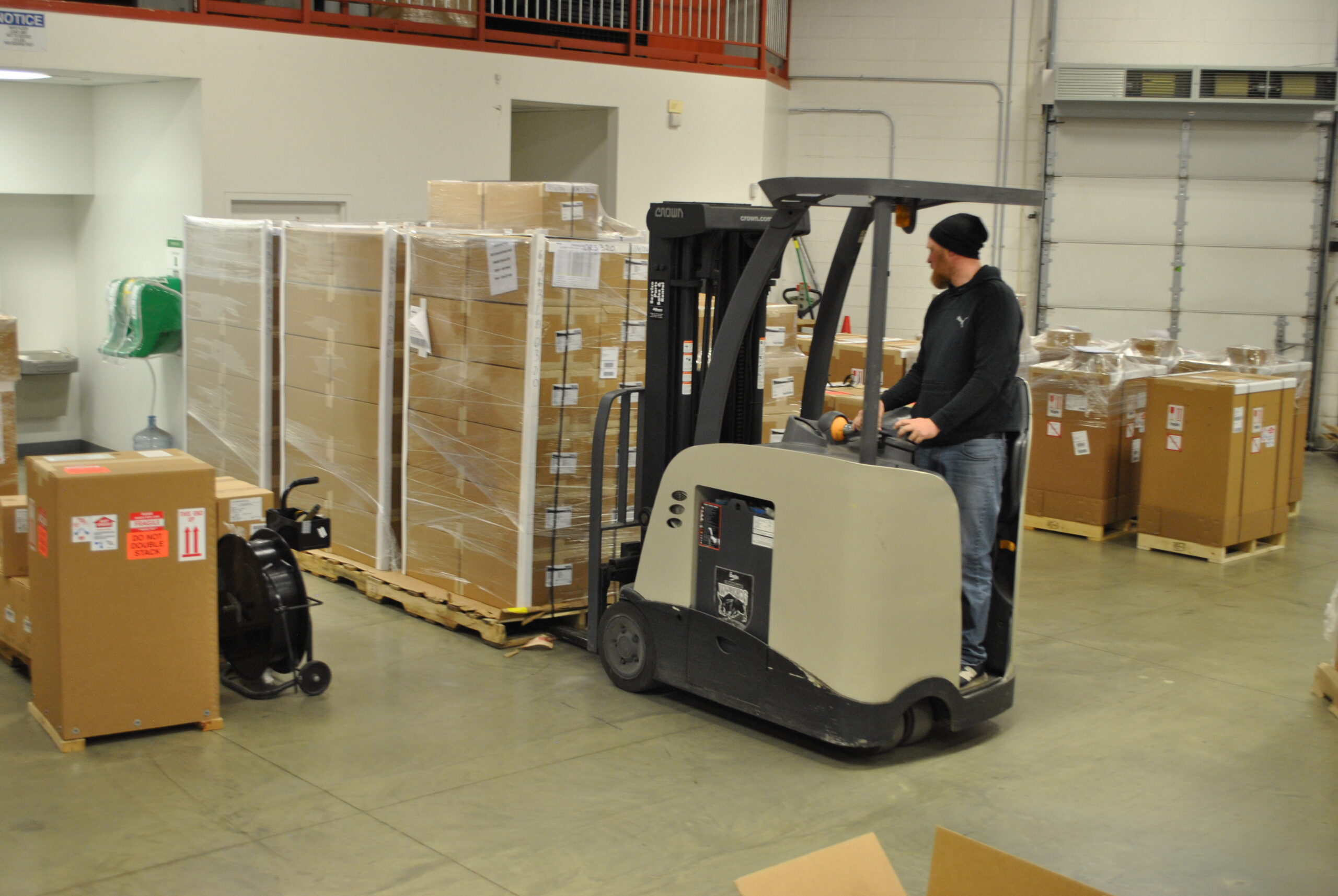 Warehouse workers boxing up products as part of the warehouse tracking inventory services MFG One provides customers.