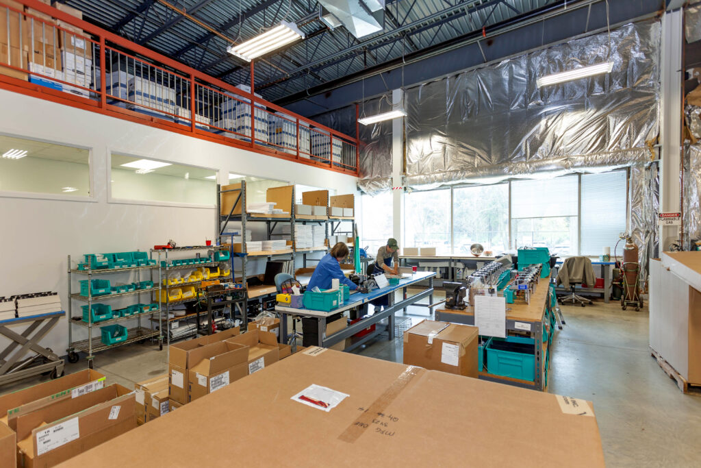 A man on a forklift working in a clean warehouse tracking inventory, demonstrating 3PL warehouse inventory management services.
