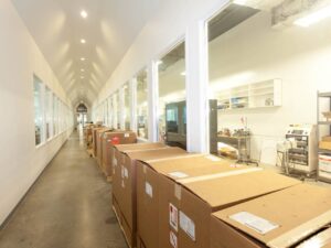 An organized hallway of finished goods ready for shipment, highlighting warehousing and logistics services.