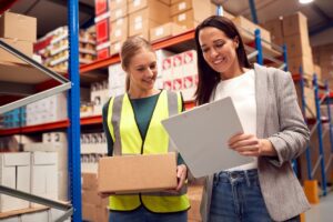 An example of electronic fulfillment services as two women review the order before the item is shipped out.